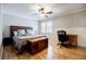 Comfortable bedroom with hardwood floors, desk, and upholstered bed at 656 Gunby Se Rd, Marietta, GA 30067