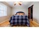 Bedroom with hardwood floors, ceiling fan, large window, and bathroom access at 656 Gunby Se Rd, Marietta, GA 30067