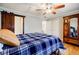 Comfortable bedroom with a sliding barn door, wood floors, and a ceiling fan at 656 Gunby Se Rd, Marietta, GA 30067