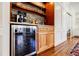 Close-up of the beverage bar with stone backsplash, shelves, wine cooler, and coffee machine at 656 Gunby Se Rd, Marietta, GA 30067