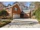 Side view of the home showing the garage, basketball hoop and driveway at 656 Gunby Se Rd, Marietta, GA 30067