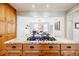 Granite island with gas cooktop, wood cabinetry, and a view into the dining area at 656 Gunby Se Rd, Marietta, GA 30067