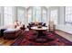 Bright living room with large windows, hardwood floors, and a decorative rug at 656 Gunby Se Rd, Marietta, GA 30067