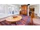 Spacious living room with a large rug, antique armoire, and access to an outdoor patio at 656 Gunby Se Rd, Marietta, GA 30067