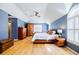 Main bedroom with blue walls, hardwood floors, and an arched window at 656 Gunby Se Rd, Marietta, GA 30067