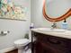 Elegant powder room featuring a decorative mirror, vanity, and fixtures at 656 Gunby Se Rd, Marietta, GA 30067