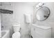 Bright bathroom featuring a stylish vanity, round mirror, and updated tile at 95 Mount Vernon Cir, Atlanta, GA 30338