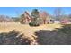 Expansive backyard showcases the brick home's architecture and mature landscaping at 1500 Elena Dr, Mcdonough, GA 30253