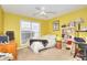 Bright bedroom features a ceiling fan, large window, and carpeted floors at 1500 Elena Dr, Mcdonough, GA 30253