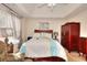 Bedroom with a large bed, high ceilings, and an armoire at 1500 Elena Dr, Mcdonough, GA 30253