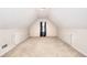 Spacious bonus room under the eaves of the roof featuring carpet flooring at 1500 Elena Dr, Mcdonough, GA 30253