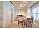Inviting dining area featuring a round table, chandelier, and natural light from a window at 1500 Elena Dr, Mcdonough, GA 30253