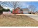 Spacious home featuring a large yard, attached garage, and traditional brick facade at 1500 Elena Dr, Mcdonough, GA 30253