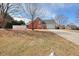 Well-maintained two-story brick home with a spacious front yard and mature trees at 1500 Elena Dr, Mcdonough, GA 30253