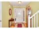 Bright foyer features hardwood floors, a staircase, and a decorative table and mirror at 1500 Elena Dr, Mcdonough, GA 30253