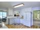 Open kitchen featuring white cabinets, stainless steel appliances, and hardwood floors at 1500 Elena Dr, Mcdonough, GA 30253