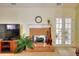 Living room with brick fireplace and French doors at 1500 Elena Dr, Mcdonough, GA 30253