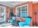 Cozy brick patio with blue chairs, offers an inviting outdoor relaxation space at 1500 Elena Dr, Mcdonough, GA 30253