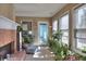 Cozy sun room with brick fireplace and bright windows at 1500 Elena Dr, Mcdonough, GA 30253