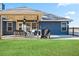 Inviting backyard patio with seating, string lights, and a well-maintained lawn at 316 Cranmore Pl, Villa Rica, GA 30180