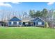 Charming blue home featuring a well-manicured lawn and stone accents at 316 Cranmore Pl, Villa Rica, GA 30180