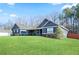 Charming blue home featuring a well-manicured lawn and stone accents at 316 Cranmore Pl, Villa Rica, GA 30180
