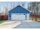 Detached two-car garage with white doors and adjacent fenced yard at 316 Cranmore Pl, Villa Rica, GA 30180