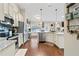 Well-equipped kitchen featuring stainless steel appliances, granite counters, a large sink, and views into the dining area at 316 Cranmore Pl, Villa Rica, GA 30180