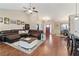 Spacious living room featuring a large leather sectional, hardwood floors, and an abundance of natural light at 316 Cranmore Pl, Villa Rica, GA 30180
