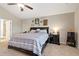 Comfortable main bedroom featuring a ceiling fan, neutral paint, and ample natural light from the window at 316 Cranmore Pl, Villa Rica, GA 30180
