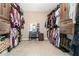 Expansive walk-in closet with custom built-in shelving and cabinets providing ample storage at 316 Cranmore Pl, Villa Rica, GA 30180