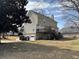 Back of the two-story home showing the deck with backyard access and lush lawn at 722 Thornapple Trl, Lawrenceville, GA 30046