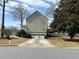 Back of the two-story home showing the two-car garage and a deck with backyard access at 722 Thornapple Trl, Lawrenceville, GA 30046