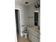 Bathroom with gray cabinets, tile floors, and a washing machine viewable in the mirror at 722 Thornapple Trl, Lawrenceville, GA 30046