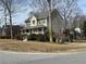Inviting two-story house with a cozy front porch, surrounded by mature trees and greenery at 722 Thornapple Trl, Lawrenceville, GA 30046
