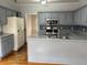 Functional kitchen with blue-grey cabinetry, stainless steel appliances, and wood flooring at 722 Thornapple Trl, Lawrenceville, GA 30046