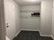 Room with tile flooring, white door, and metal shelving at 722 Thornapple Trl, Lawrenceville, GA 30046
