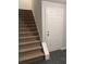 Carpeted stairs leading up to a white door at 722 Thornapple Trl, Lawrenceville, GA 30046