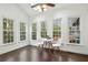 Sunlit breakfast nook with multiple windows, a small table, and modern chairs at 11910 Wildwood Springs Dr, Roswell, GA 30075