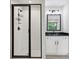 Stylish bathroom with glass enclosed shower, vanity with black countertop and contemporary lighting at 1511 New Hope Rd, Locust Grove, GA 30248
