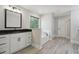 Bright bathroom boasts double vanity, soaking tub, modern fixtures, and wood-look tile at 1511 New Hope Rd, Locust Grove, GA 30248