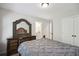 Comfortable bedroom featuring a beautiful wood dresser with a decorative mirror and a gray comforter at 1511 New Hope Rd, Locust Grove, GA 30248