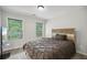 Cozy bedroom with two large windows and a comfortable queen bed with natural wood frame at 1511 New Hope Rd, Locust Grove, GA 30248