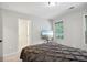 Bright bedroom featuring a comfortable queen bed and a large window with natural lighting at 1511 New Hope Rd, Locust Grove, GA 30248