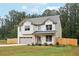 Attractive two-story home with a grey roof, well-manicured lawn, and picket fence at 1511 New Hope Rd, Locust Grove, GA 30248