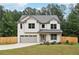 Charming two-story home with attached garage and beautifully landscaped front yard at 1511 New Hope Rd, Locust Grove, GA 30248