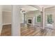 Open-concept living room boasts hardwood floors, a fireplace, natural light, and access to the outdoors at 1511 New Hope Rd, Locust Grove, GA 30248