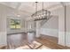 Inviting Living Room with a modern light fixture and large windows at 1511 New Hope Rd, Locust Grove, GA 30248