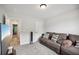 Inviting living room with a comfortable brown sectional couch and a flat-screen television at 1511 New Hope Rd, Locust Grove, GA 30248