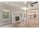 Bright living room featuring a fireplace, ceiling fan, and hardwood floors at 1511 New Hope Rd, Locust Grove, GA 30248